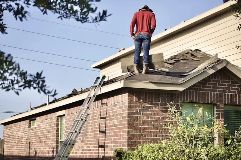 Professional roofer working on a residential roof in Uniondale
